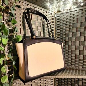 A New Day Breifcase bag, black and white with gold hardware.